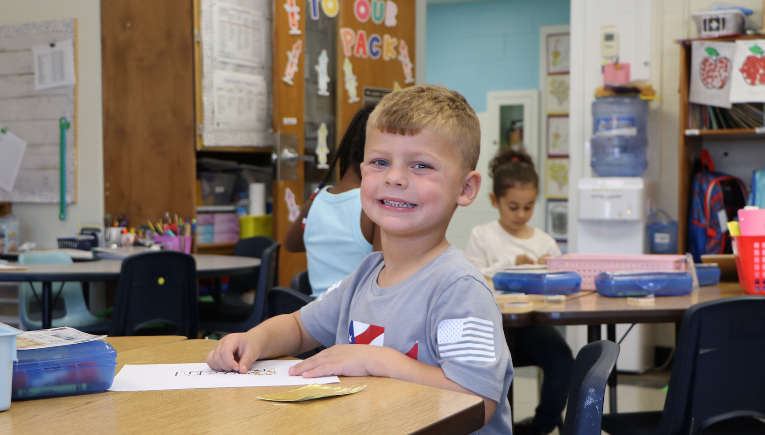 student with grey shirt and American flag