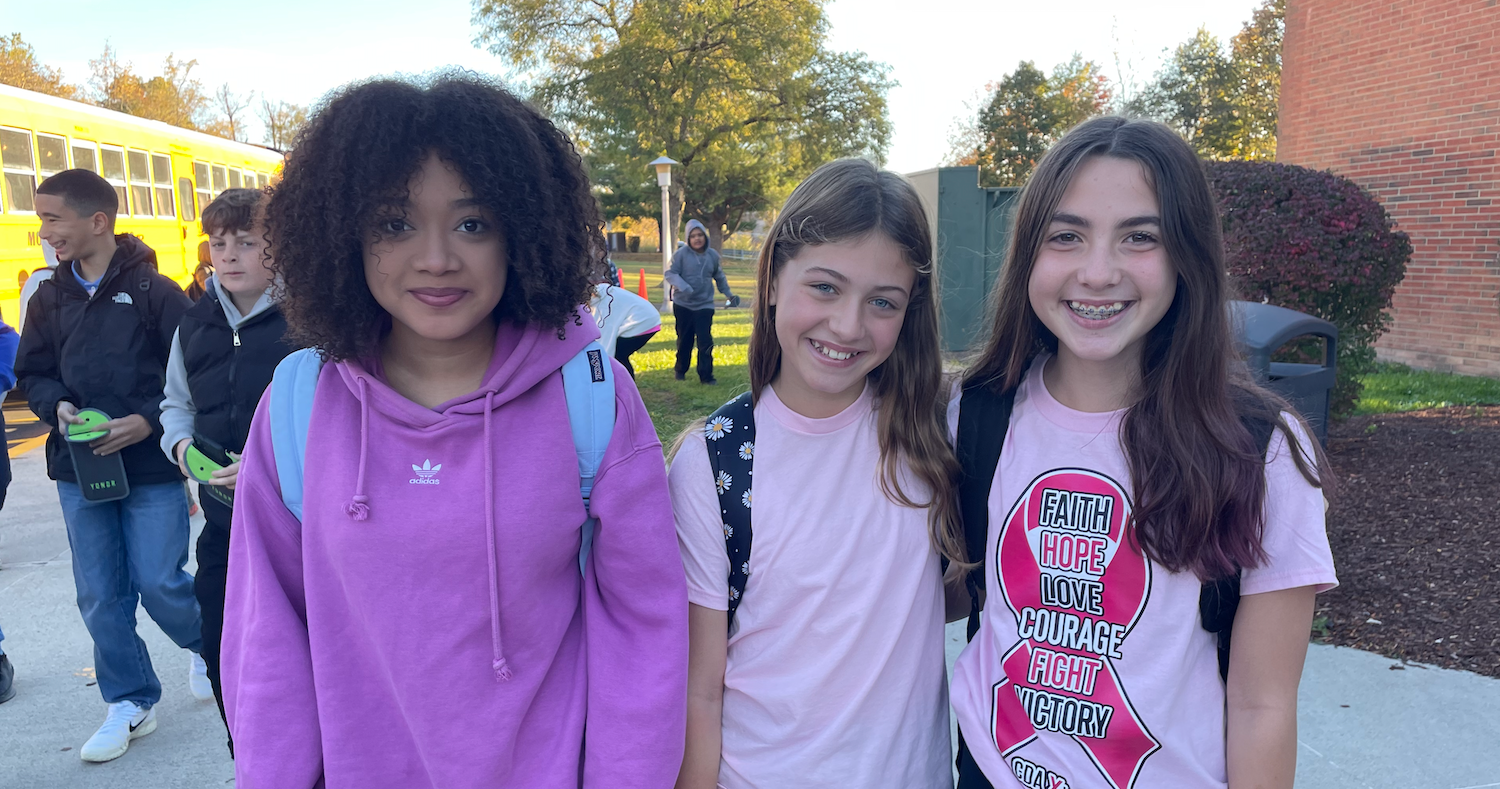 three students wearing pink