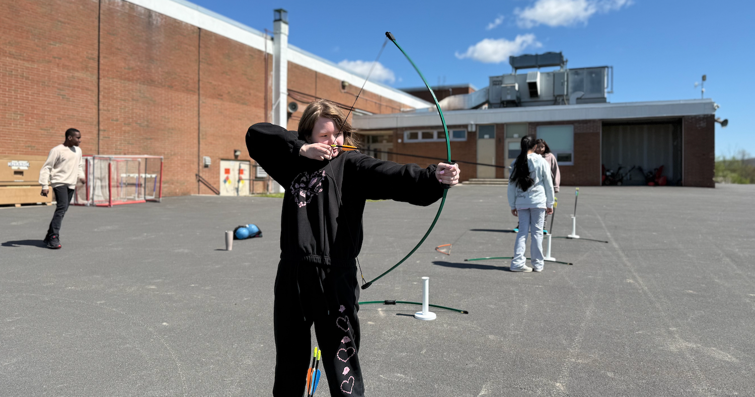 student holding bow and arrow