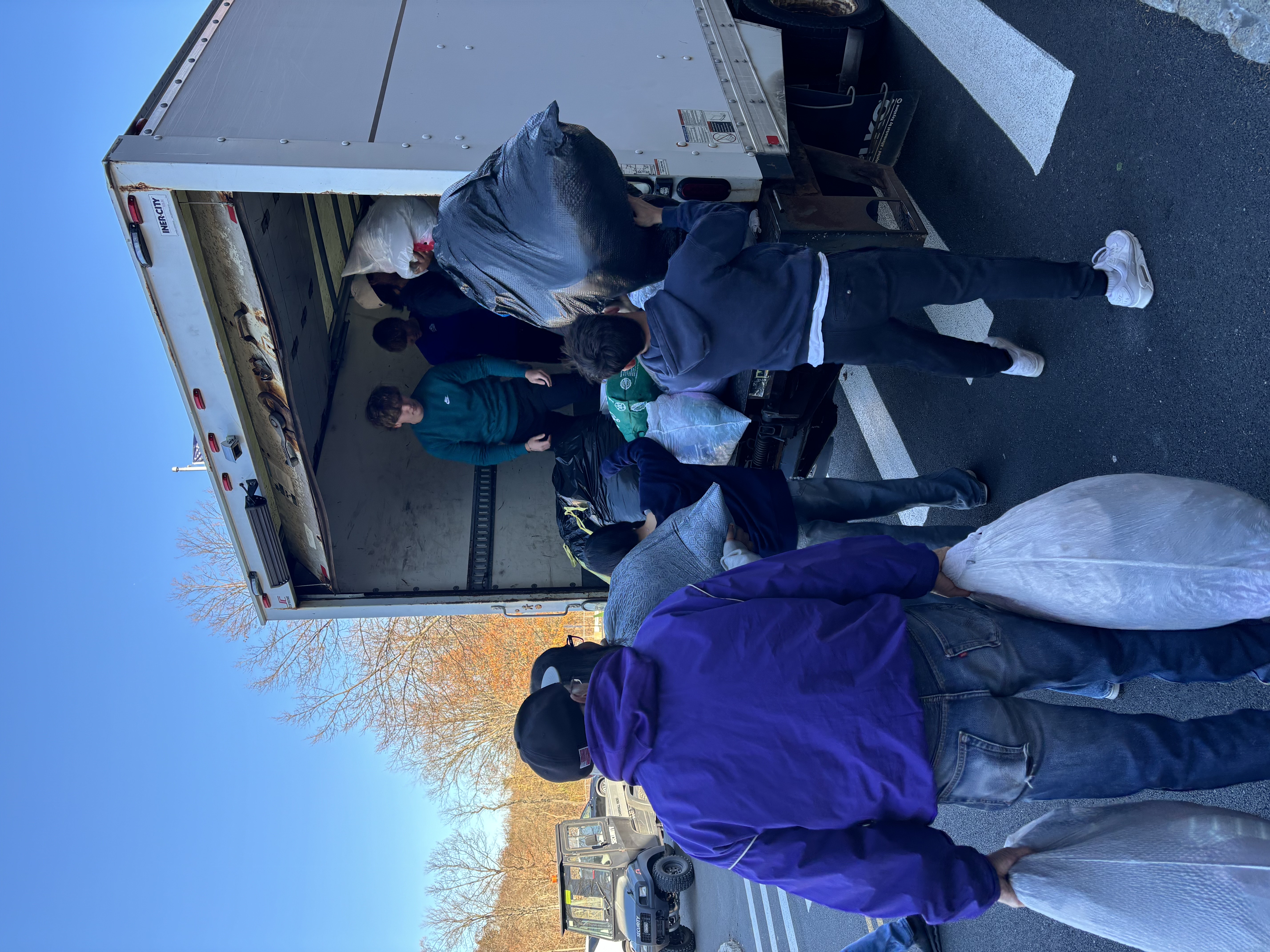 students loading donations on the truck