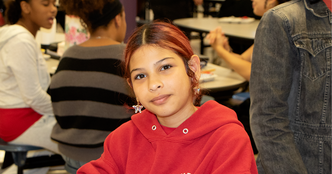 student in a red shirt with red hair