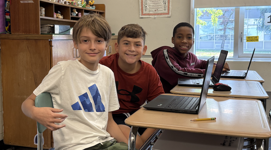 three students sitting at a table