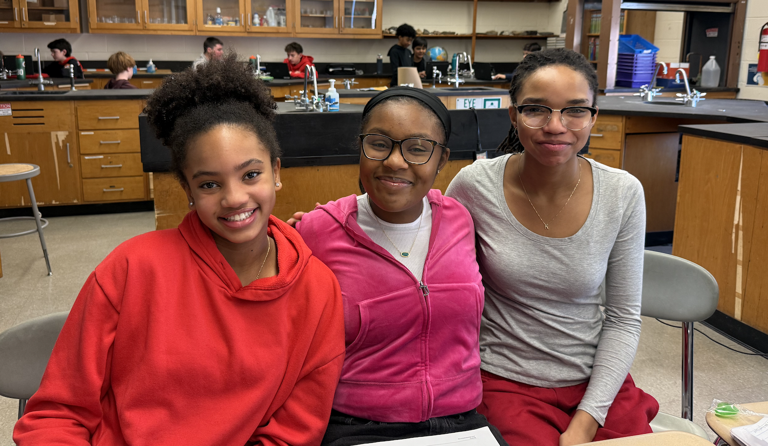 three students sitting at table