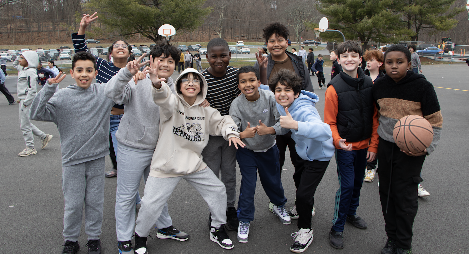 students standing on basketball court