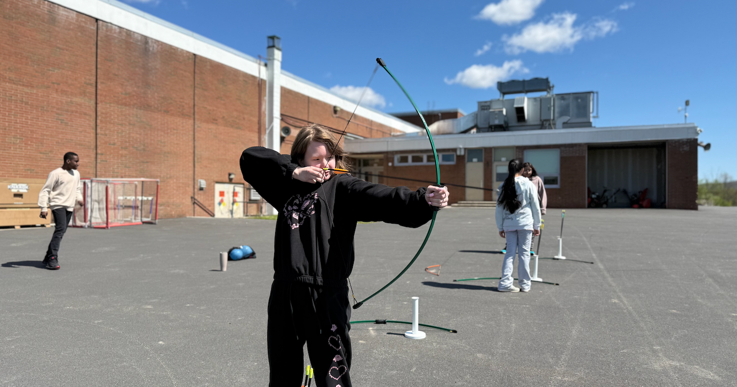 student holding bow and arrow