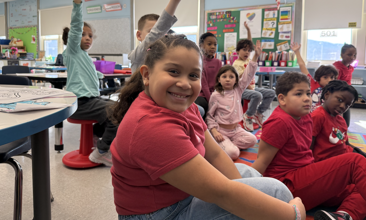 student smiling sitting on floor