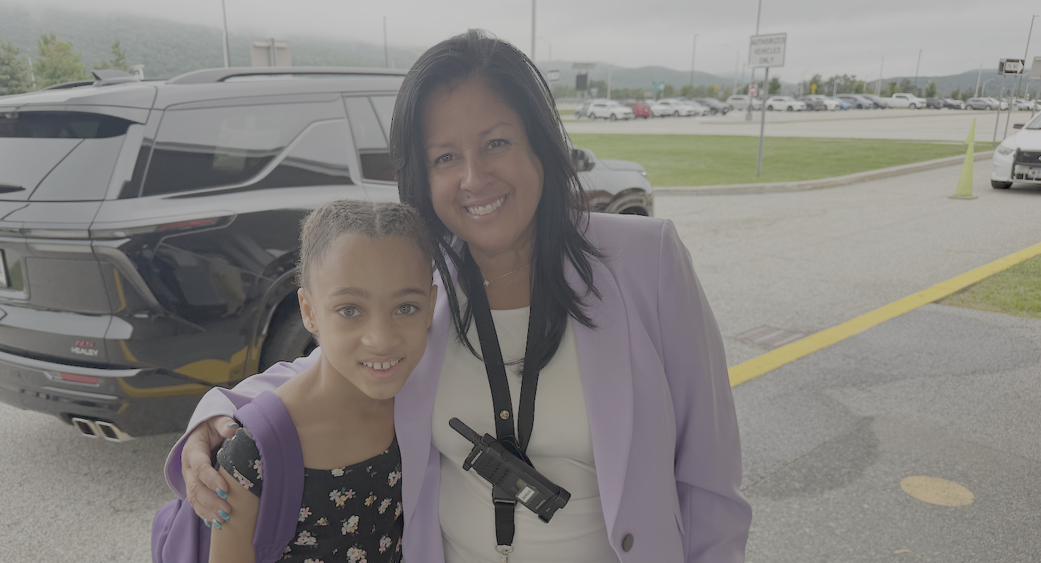 student with the principal on the first day of school