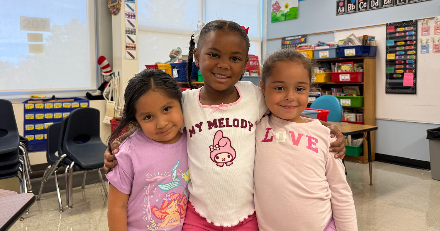 three students wearing pink shirts