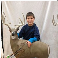 A photo of a student with a deer used as a target.