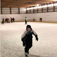A photo of students playing in the ice rink.