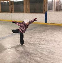 A photo of students playing in the ice rink.