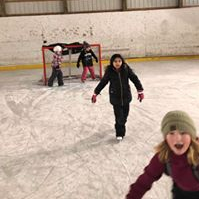 A photo of students playing in the ice rink.