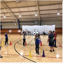 A photo of students playing in the gymnasium.