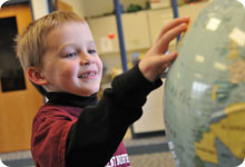 Student playing with a toy globe