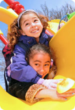 Two girls playing in the playground