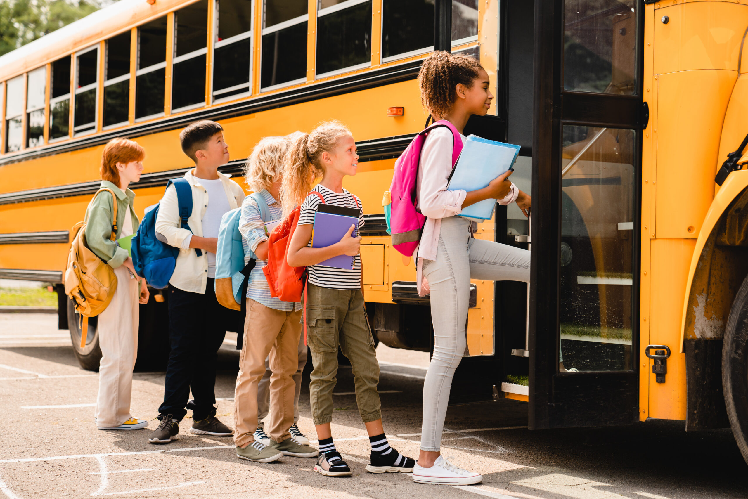 Kids getting on a school bus