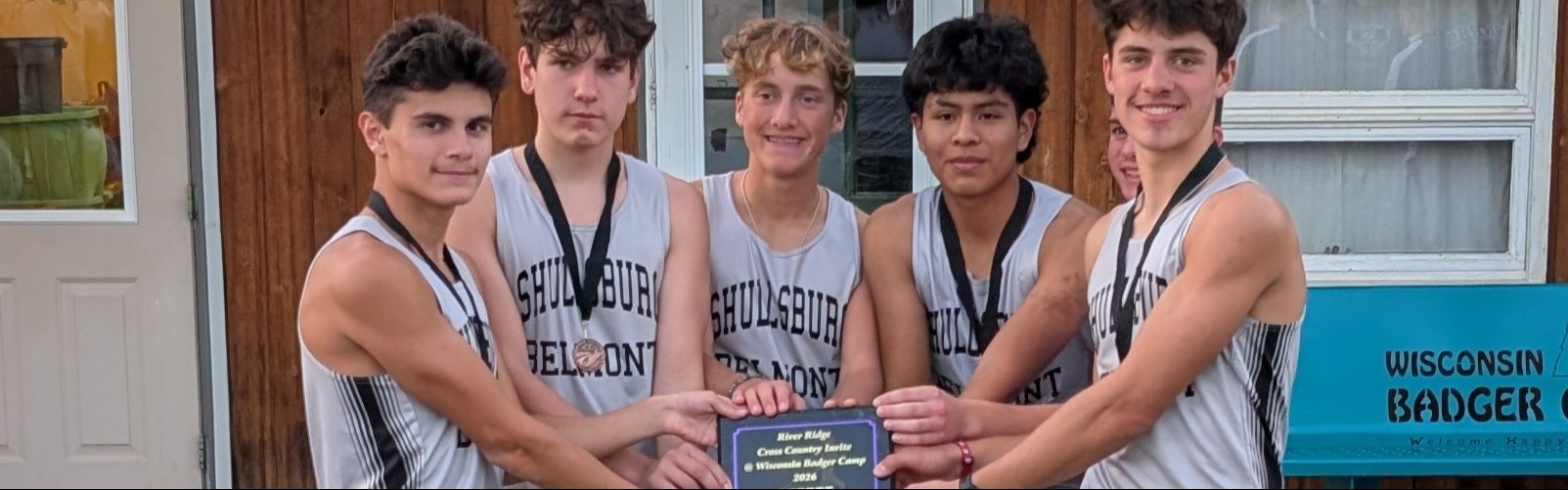 Boys' Cross Country team first place photo with plaque.