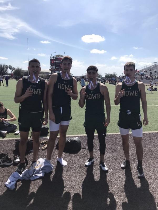 4 track students biting on medals