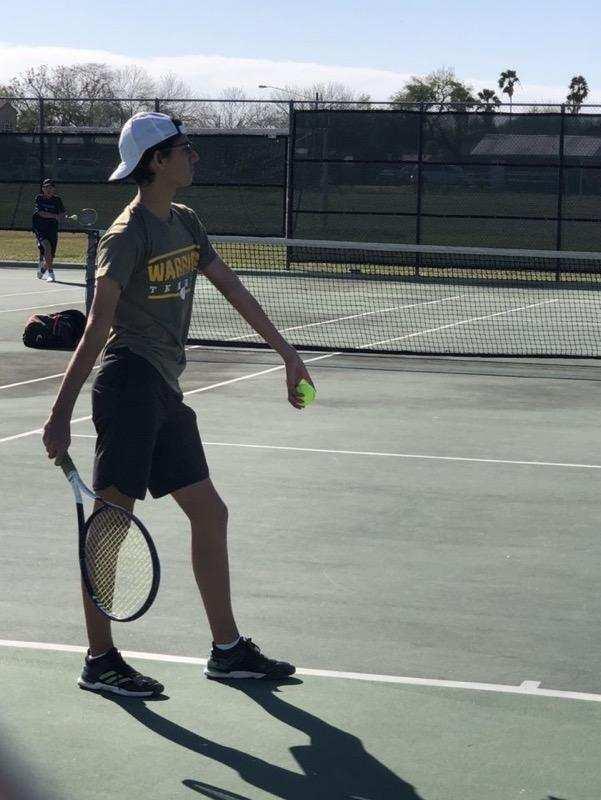 Student getting ready to serve tennis ball