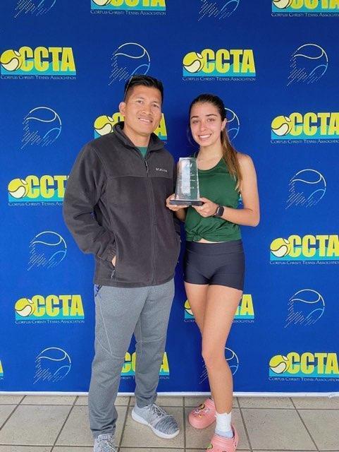 Female student with trophy and coach