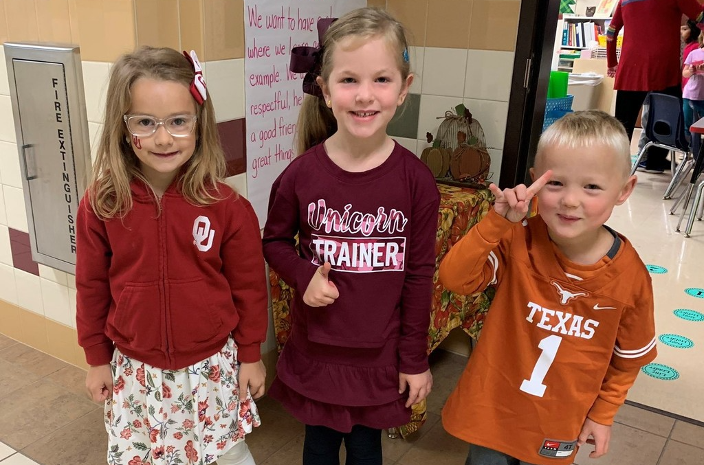 Elementary students wearing college gear