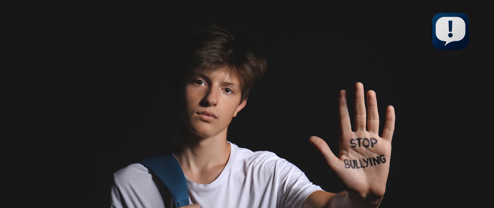 student with stop bullying written on his hand