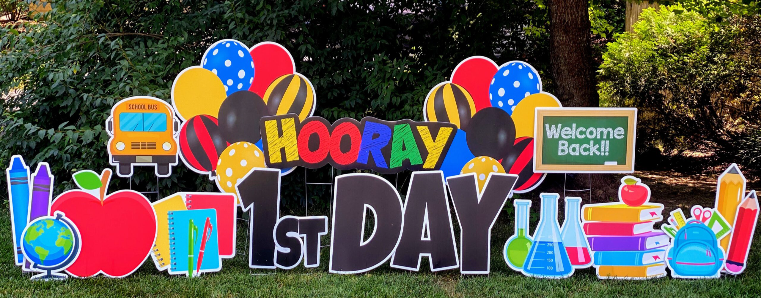 hooray 1st day! Welcome Back sign with balloons, school supplies, school bus, crayons, books, pencils, apple