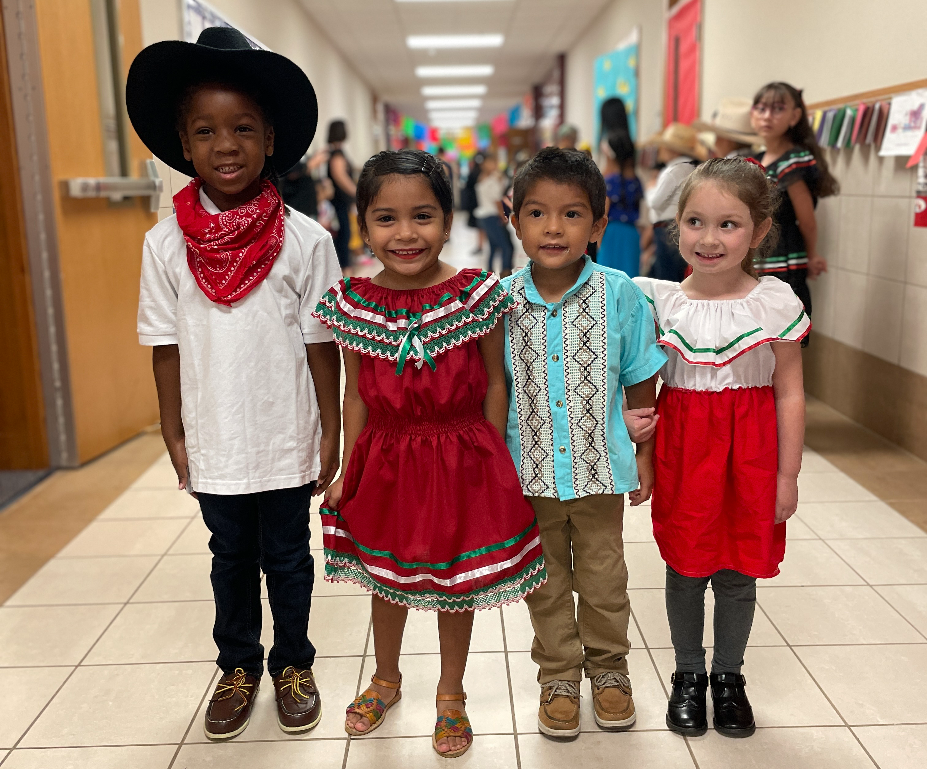 elementary aged children dressed in Hispanic traditional attire