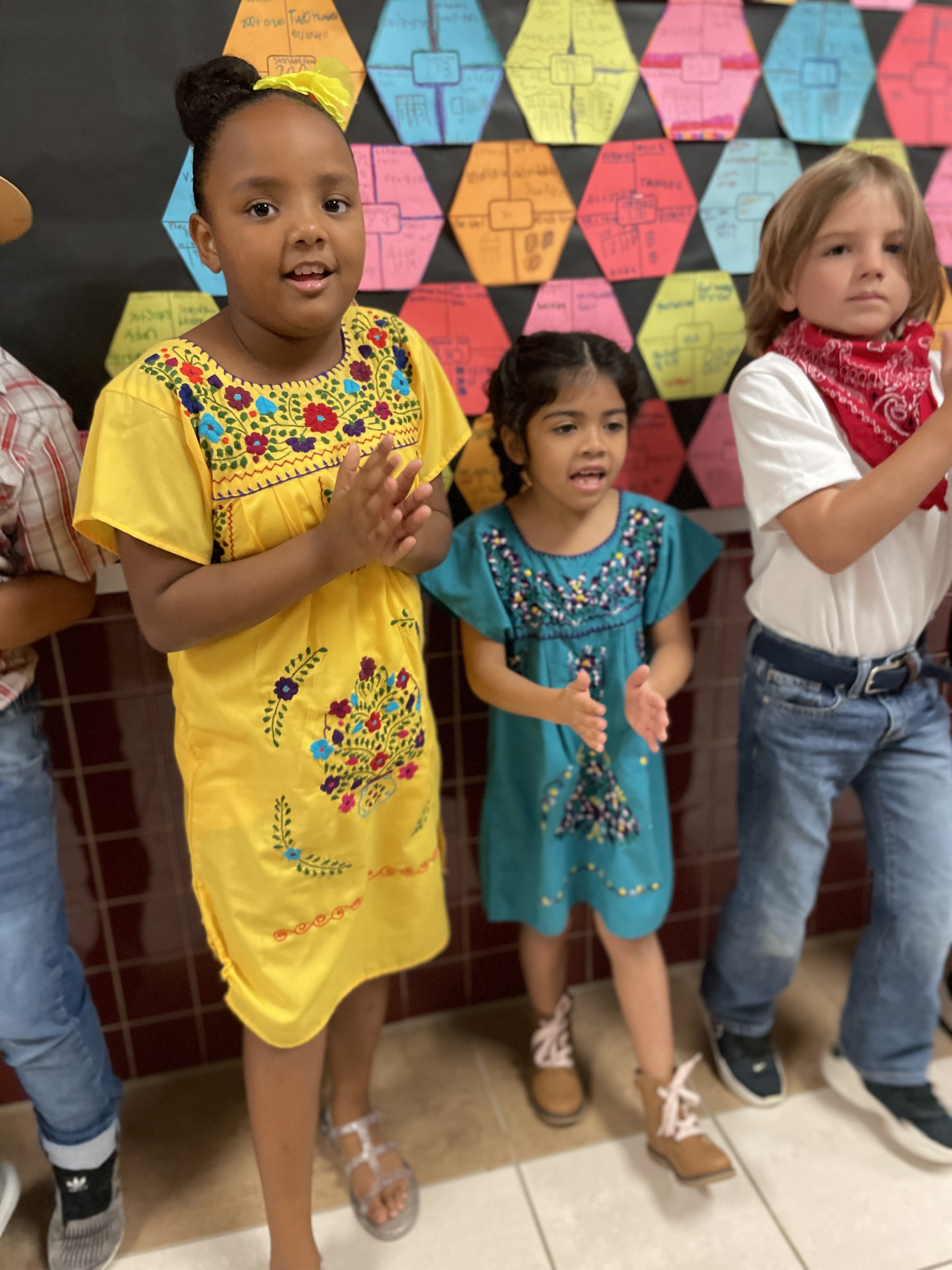 elementary aged children dressed in Hispanic traditional attire