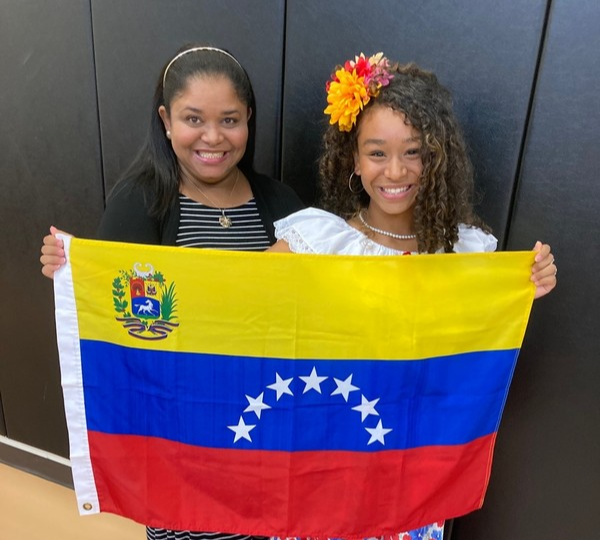 two women holding Venezuela flag