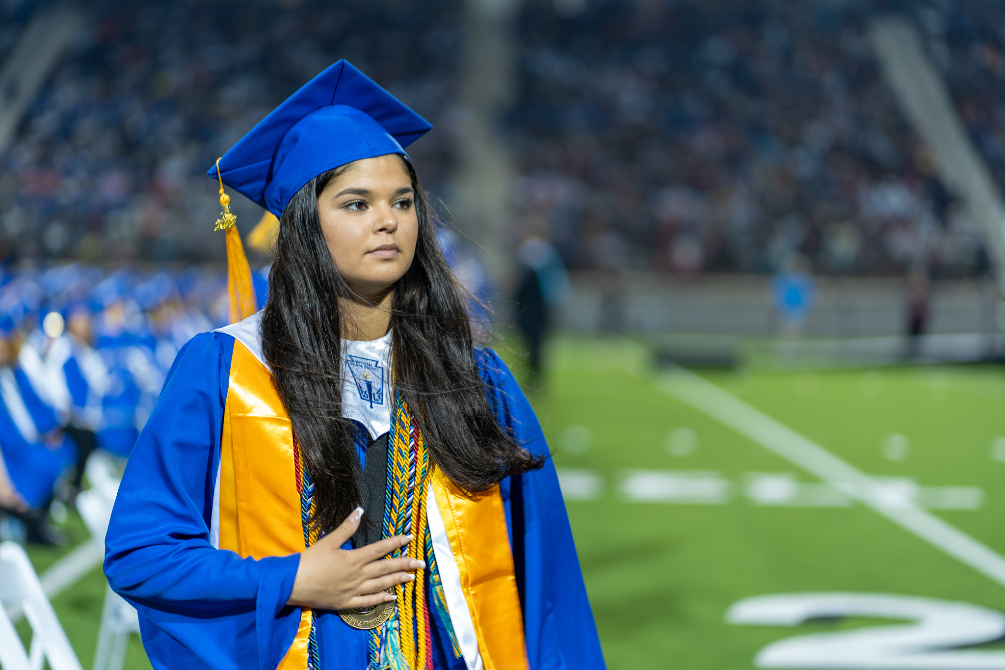 tyler high school student walking with graduation cap and gown