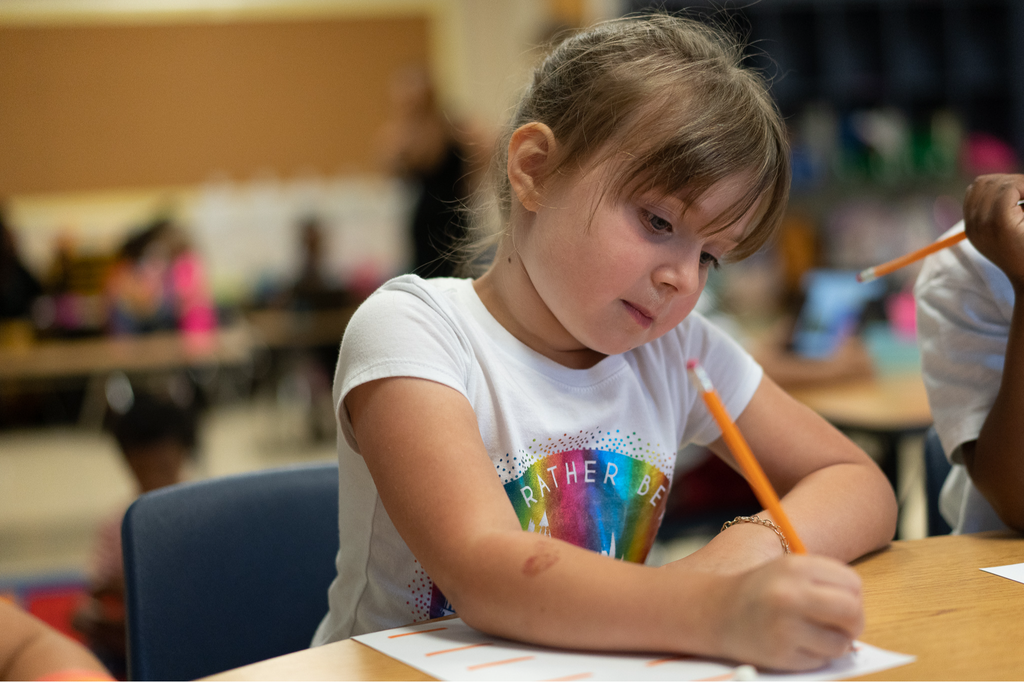 student writing with pencil