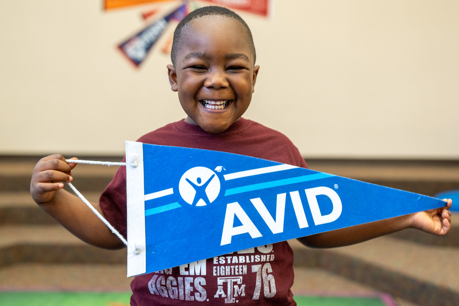 students posing with avid pennant