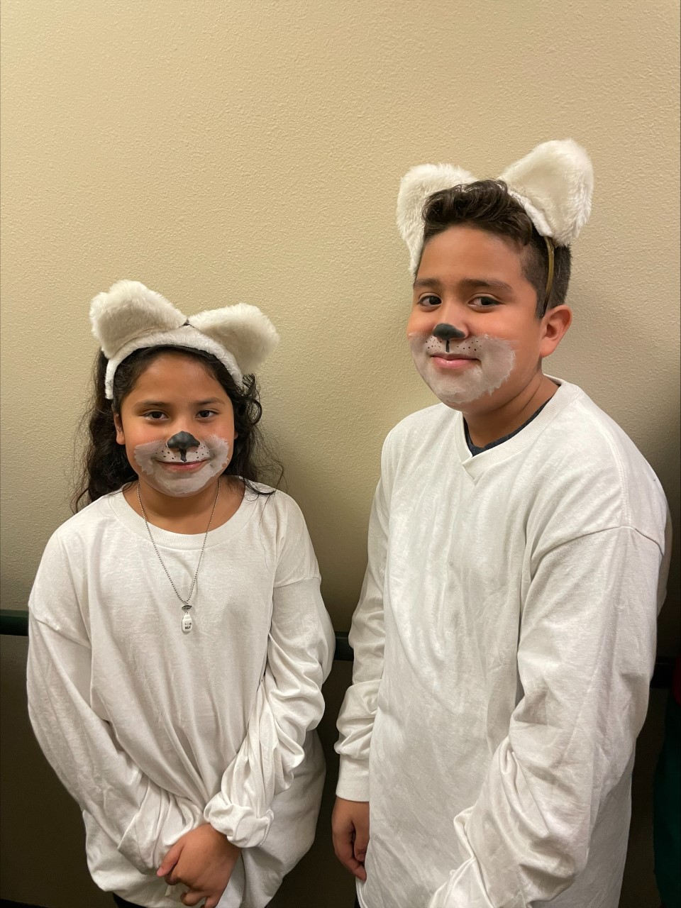 elementary aged boy and girl dressed as polar bears