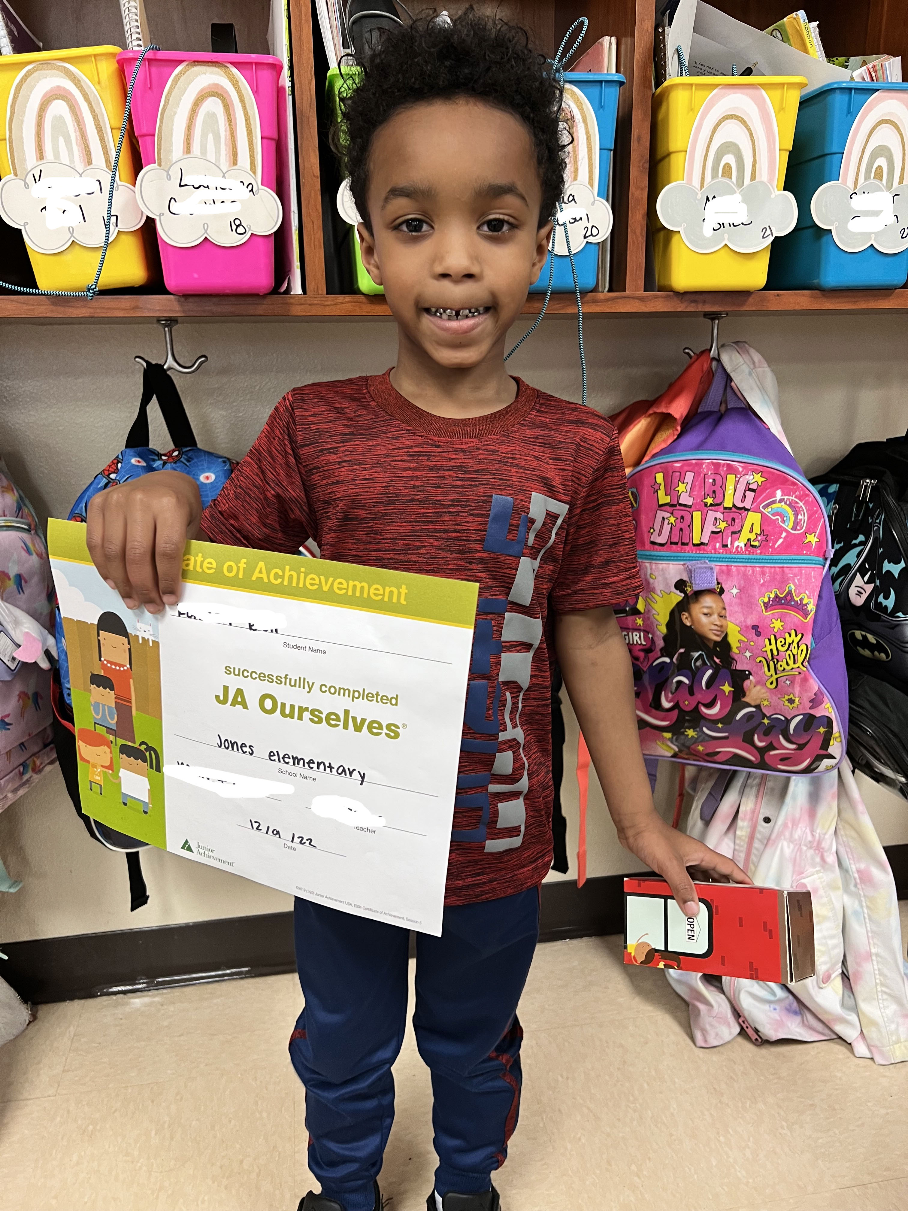 African American boy holding a certificate