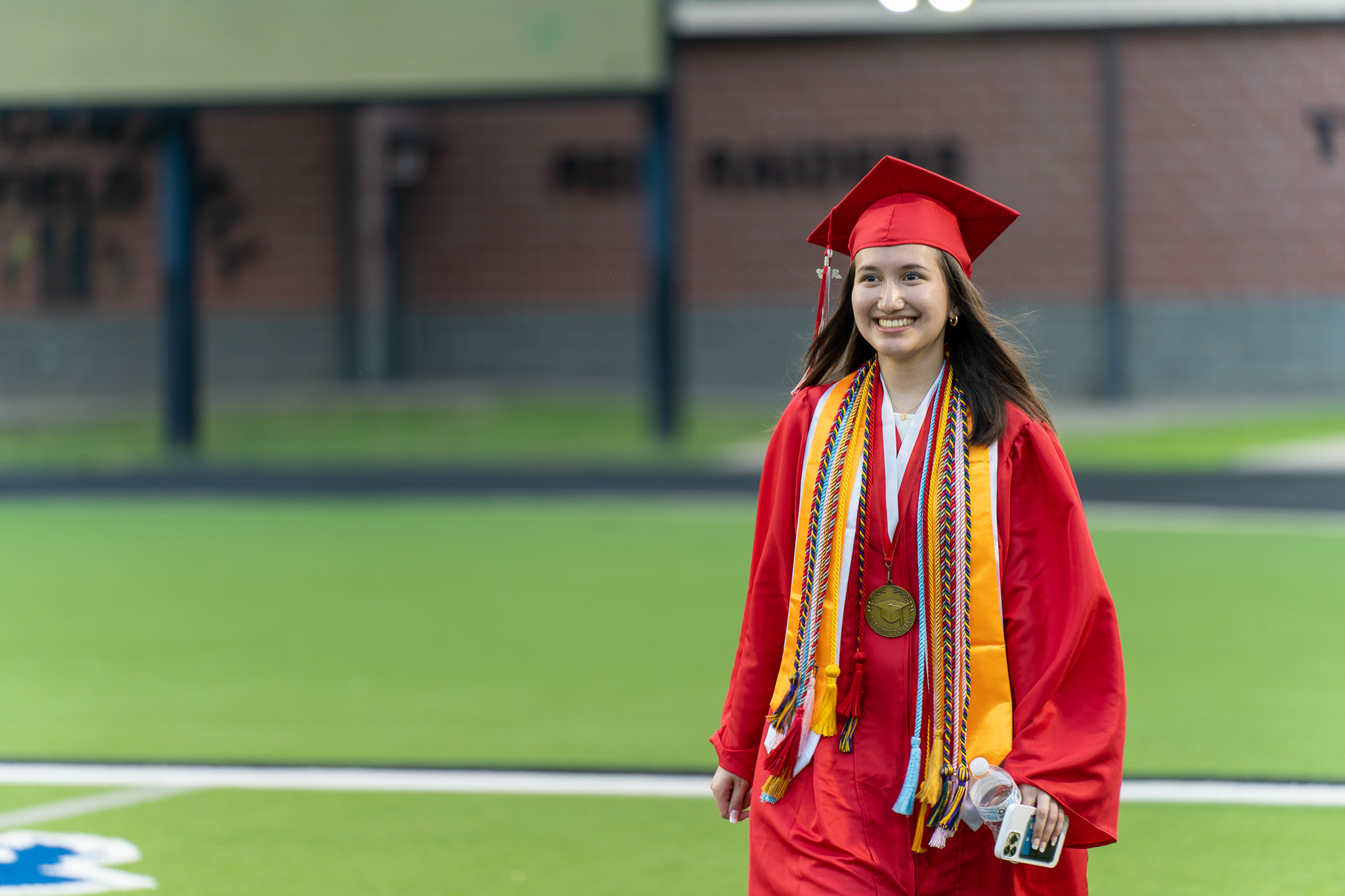 student walking in graduation gown