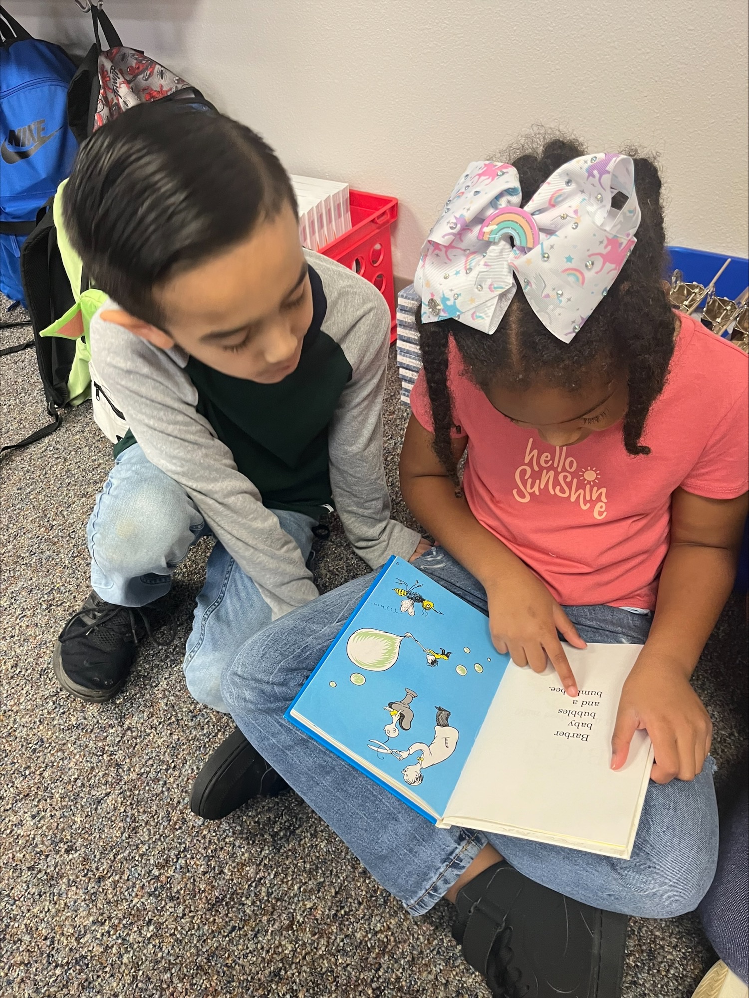two elementary age girls reading a book