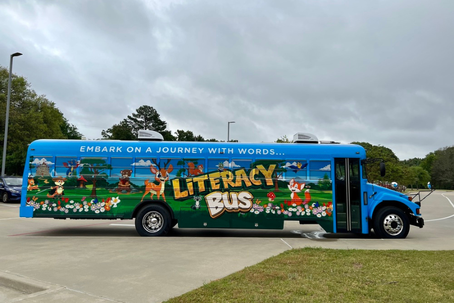 Literacy Bus, a school bus painted blue with animal characters on it