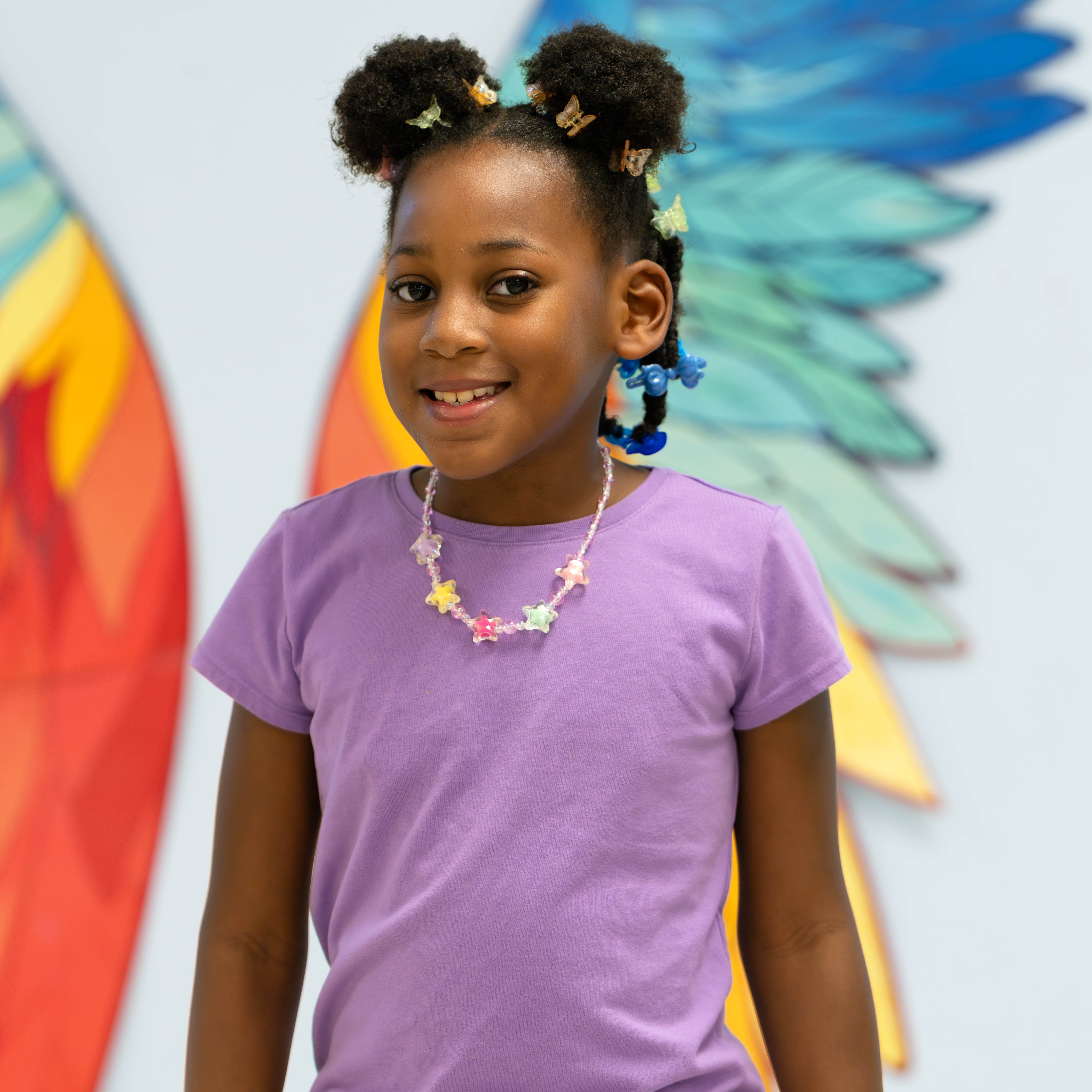 elementary age African American girl wearing a purple tshirt