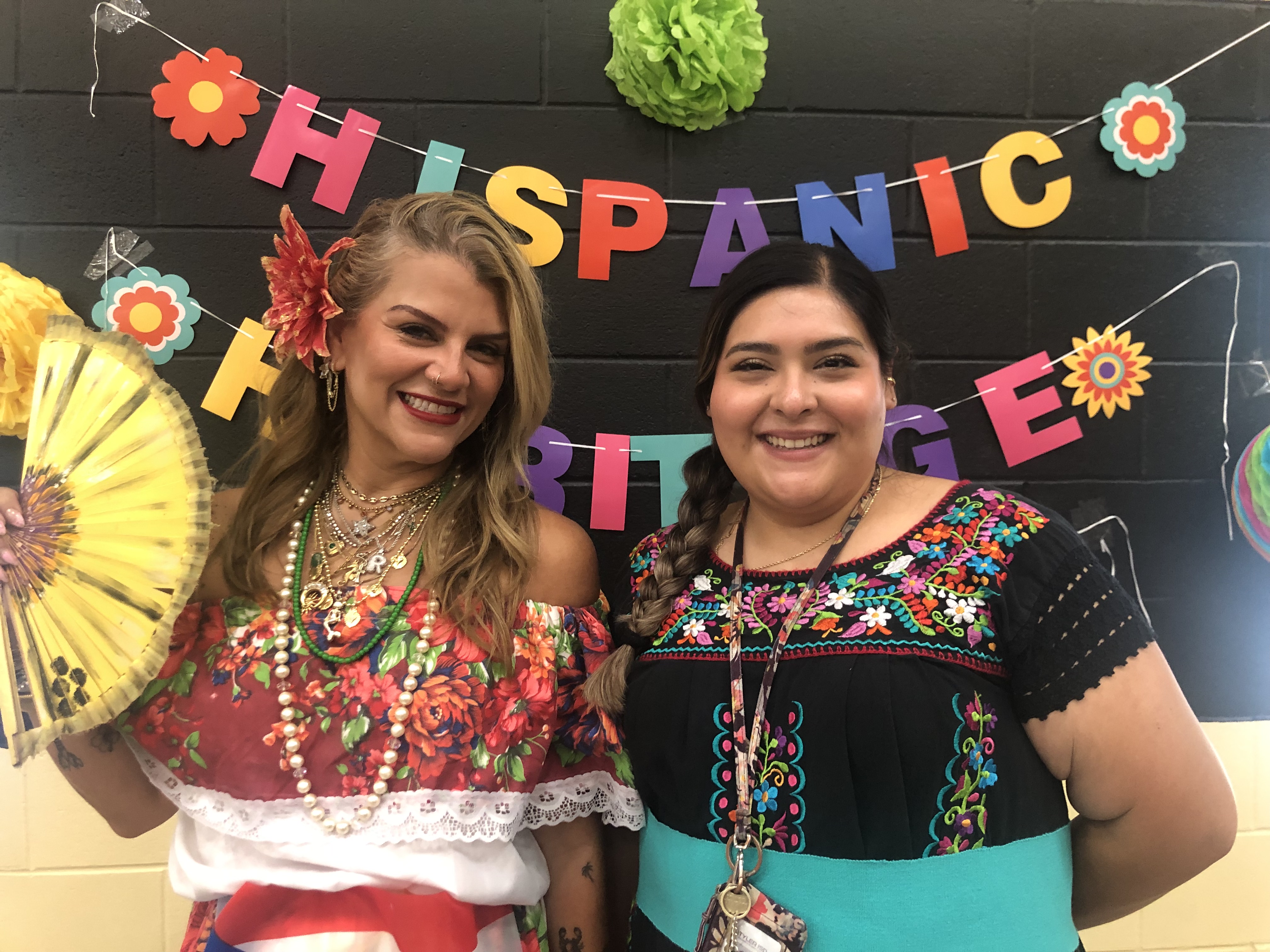 two women wearing traditional Mexican dresses