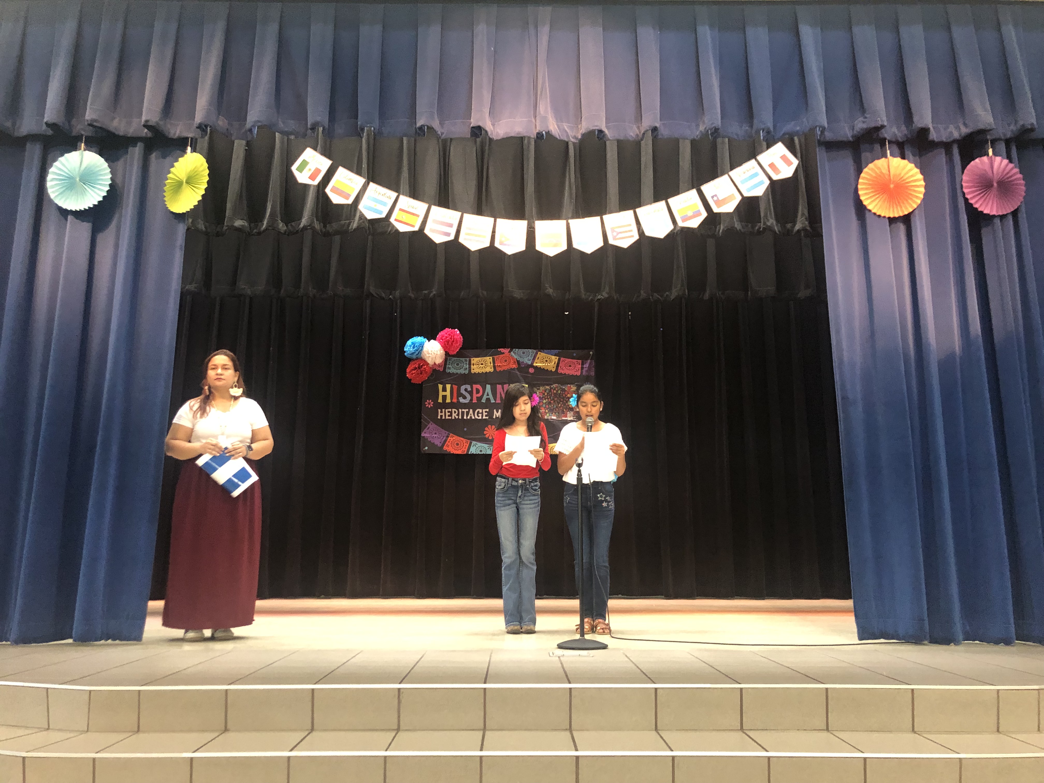 two students standing on a stage