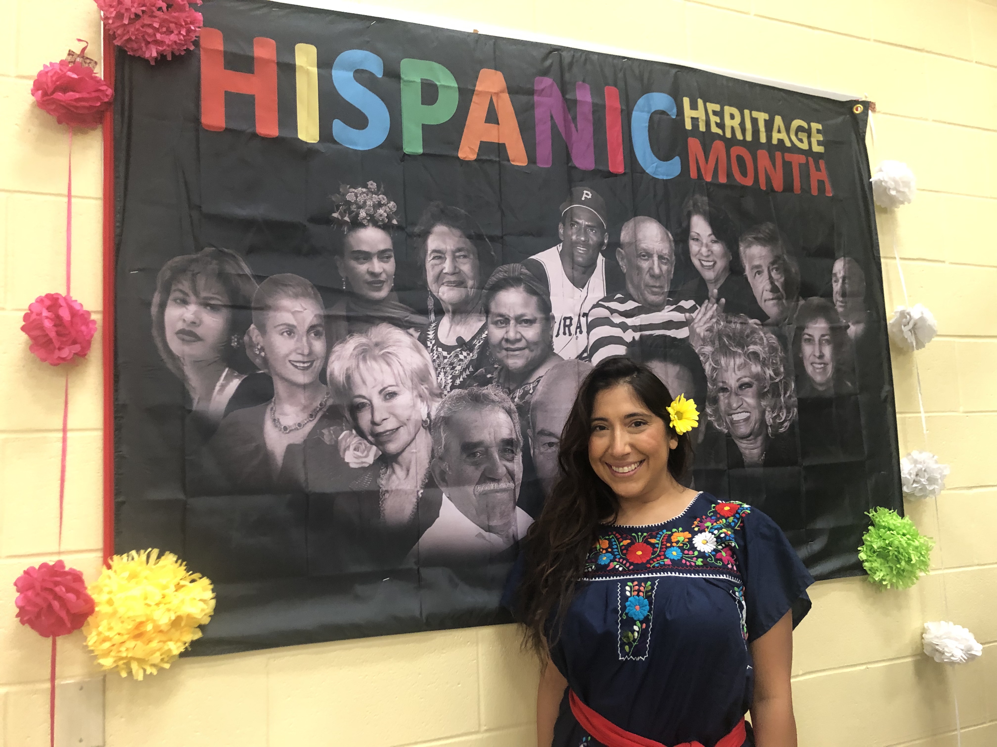 woman standing in front of a poster on a wall