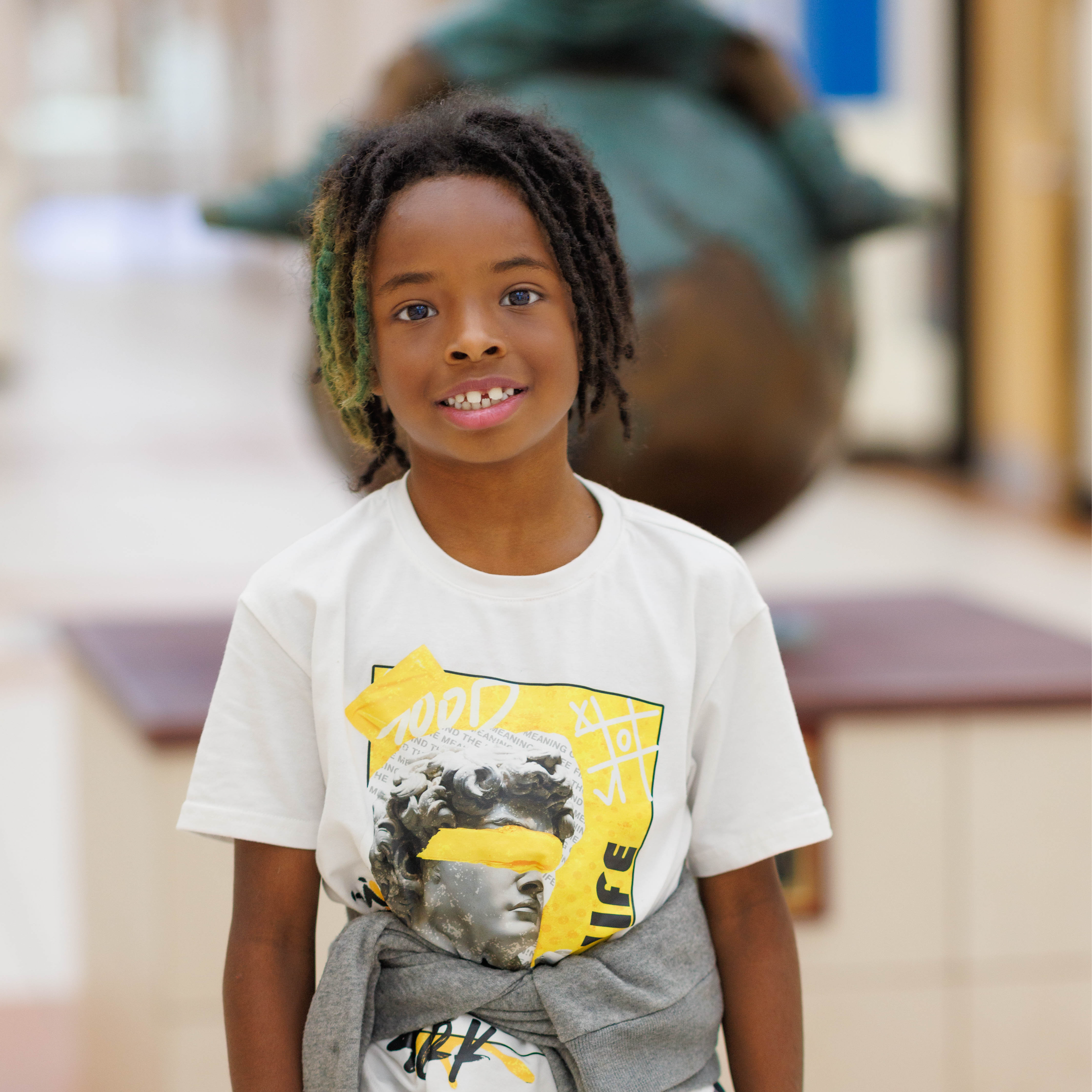 elementary age boy wearing white t-shirt