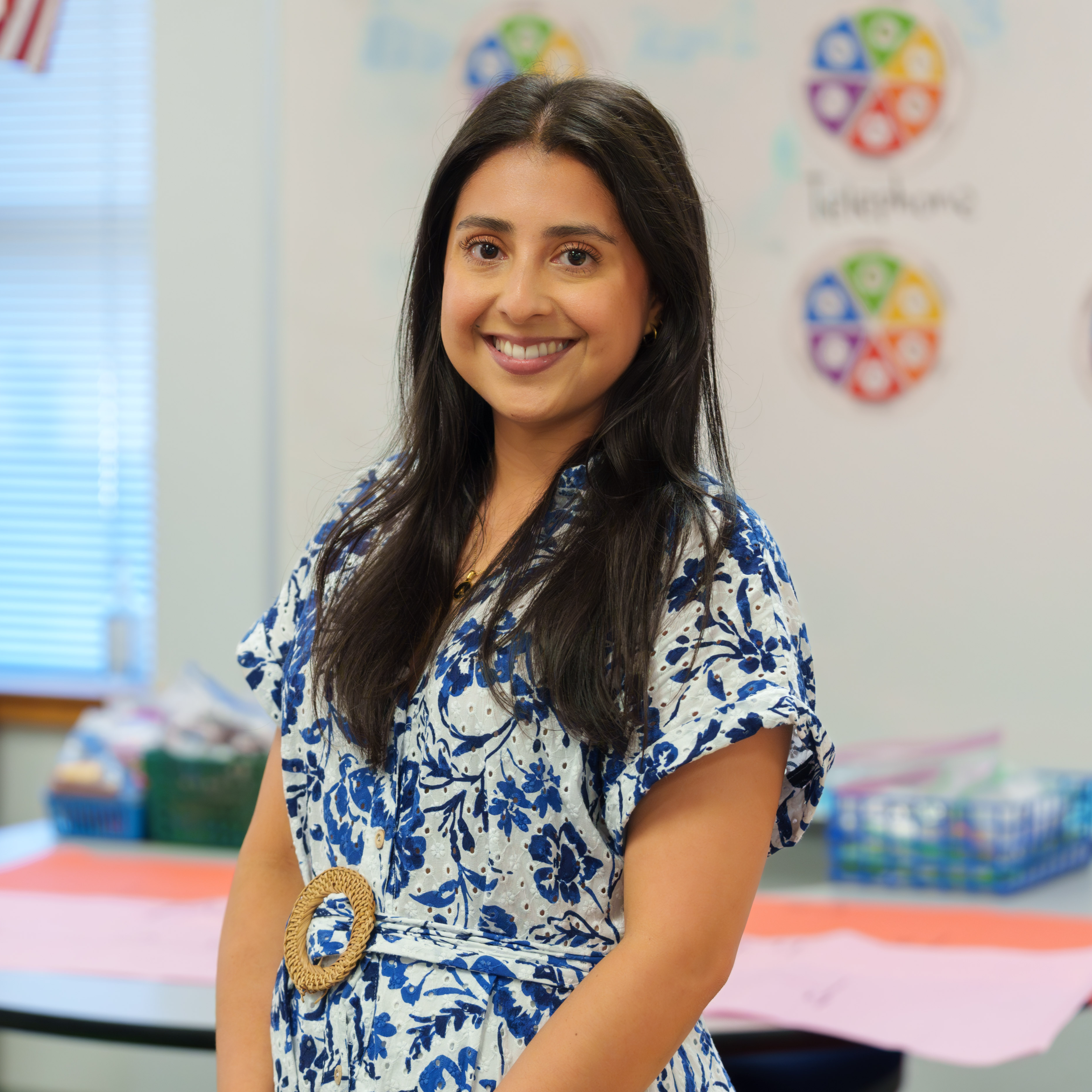 Hispanic woman wearing a blue floral dress