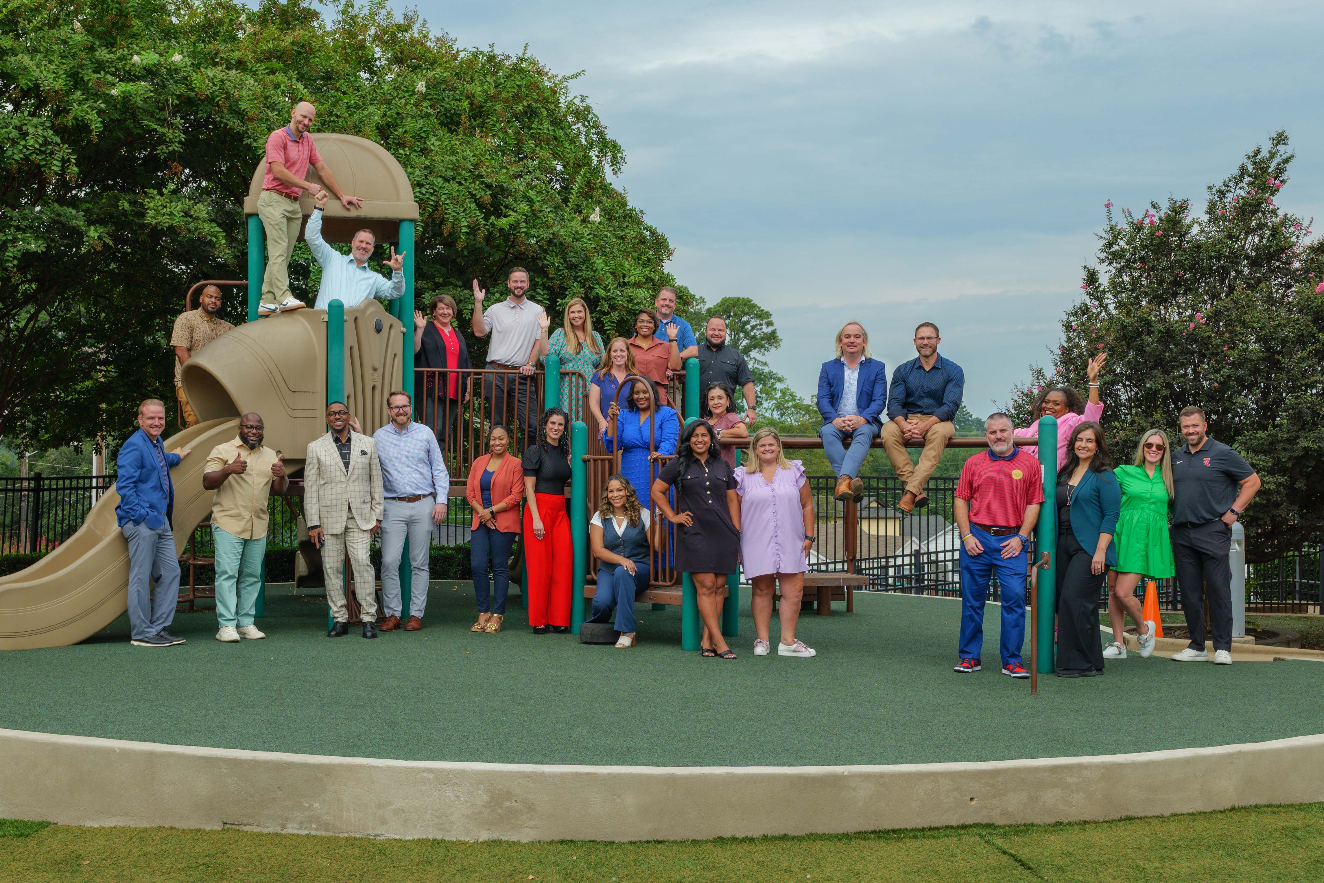 adults standing on playground equipment