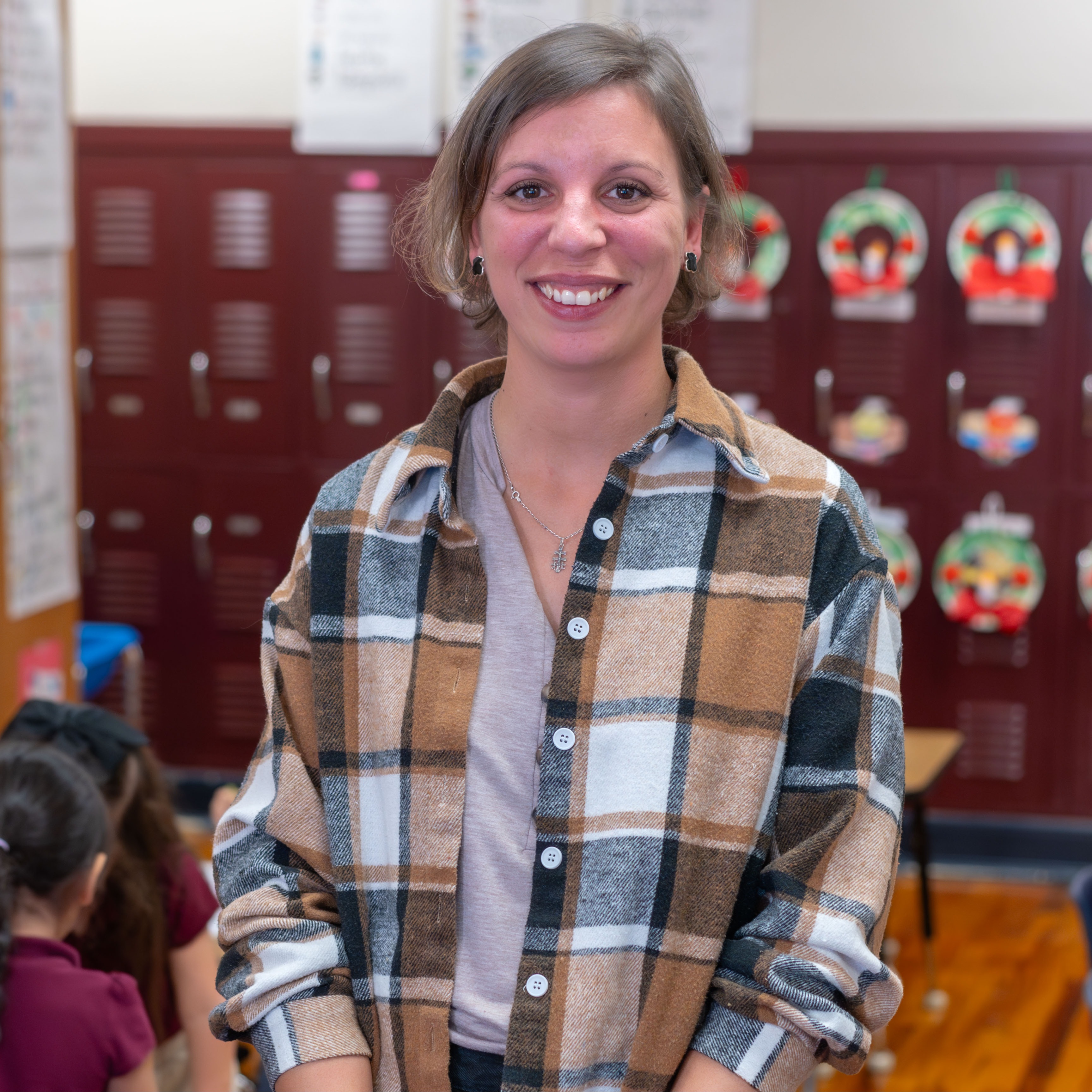 woman wearing plaid shirt in classroom