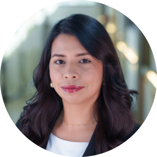 Hispanic woman with long dark hair wearing a white blouse and black jacket