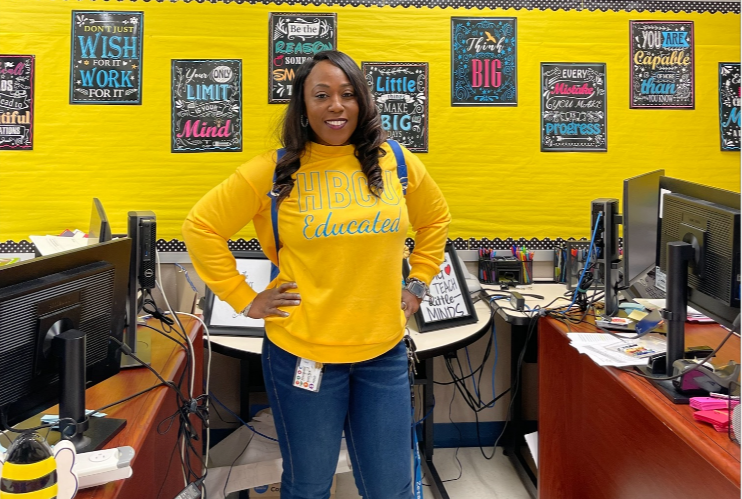 woman in yellow shirt standing in classroom