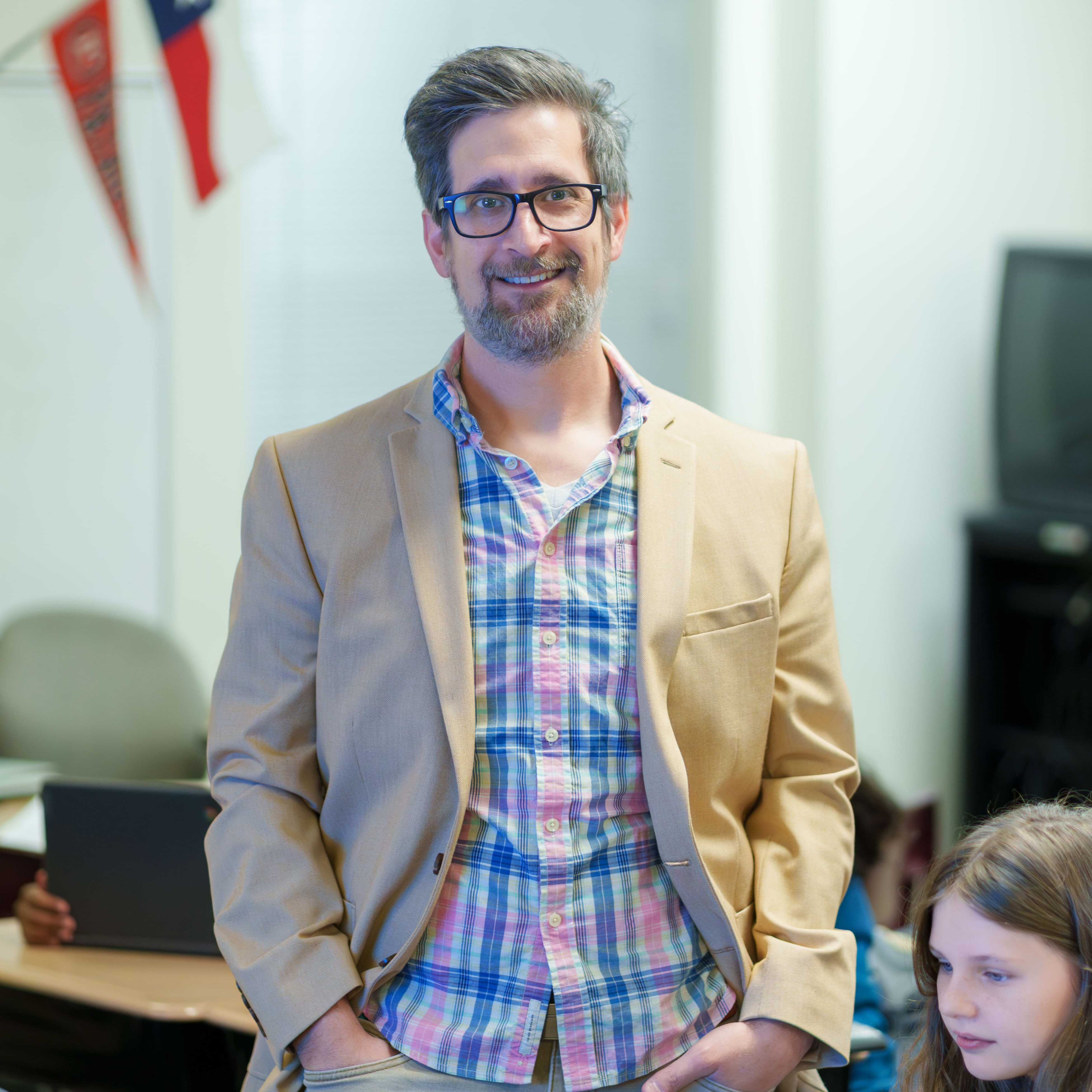 Caucasian man wearing plaid shirt and jacket