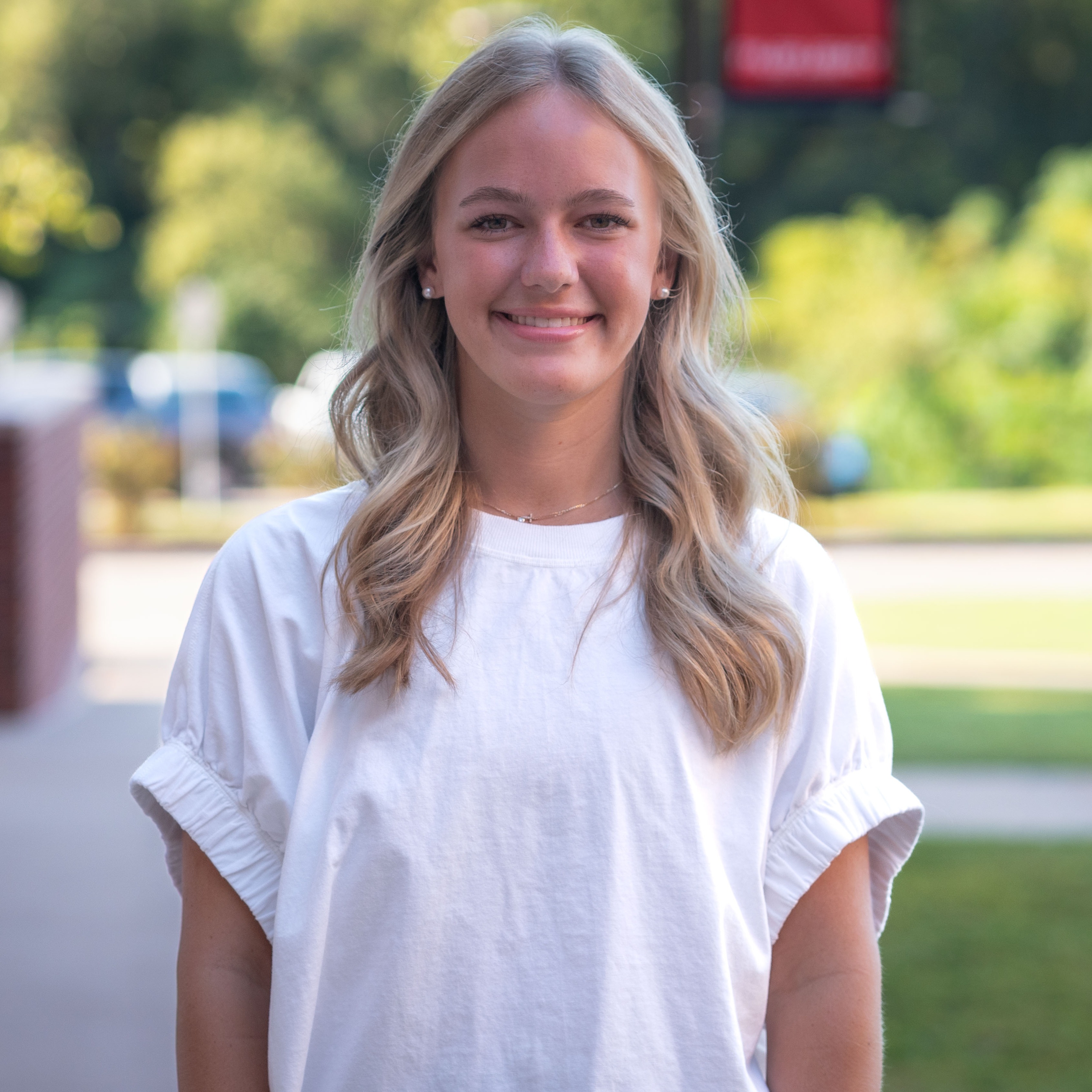high school girl with long blonde hair wearing a white blouse